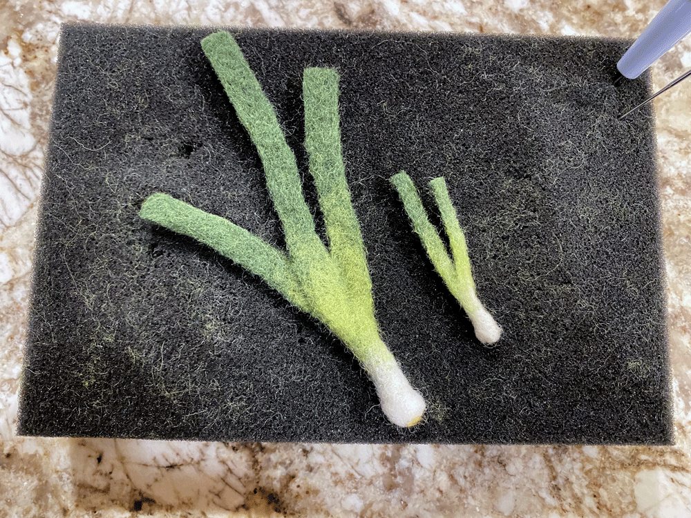Two needle felted green onions